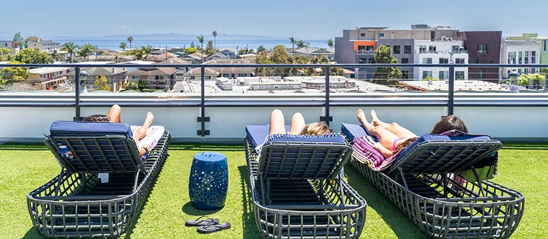 The rooftop sundeck with grill at ICON Apartments overlooking Isla Vista and the ocean